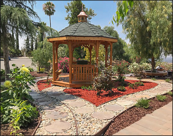 10 Cedar Octagon Belle Roof Gazebo shown with Red Cedar Deck, Rustic Evergreen Asphalt Shingles, 4 Bench sections, Cedar Tongue and Groove Ceiling, Cupola, and Clear Stain/Sealer.