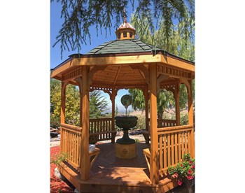 10 Cedar Octagon Belle Roof Gazebo shown with Red Cedar Deck, Rustic Evergreen Asphalt Shingles, 4 Bench sections, Cedar Tongue and Groove Ceiling, Cupola, and Clear Stain/Sealer.