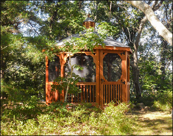 10 Cedar Octagon Gazebo shown with cedar Deck, 2x2 Square Railings, Cupola, Old English Pewter Asphalt Shingles, Full Set of Screens & Screen Door, Cedar Stain/Sealer, and Stainless Steel Hardware. c