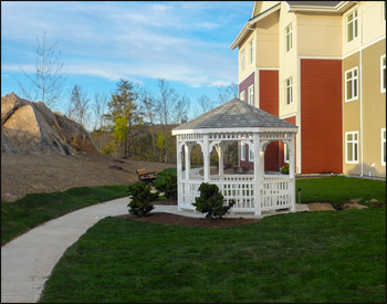 10 Vinyl Octagon Gazebo shown with No Deck, 1x1 Standard Rails, Wavy Fascia, Finished Vinyl Ceiling, Old English Pewter Asphalt Shingles, and Bench Sections. 