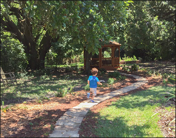 12 Treated Pine Octagon Gazebo shown with a treated pine deck, 2x2 decorative spindle rails, decorative braces, full set of screens and screened door, cedar stain/sealer, and Rustic Cedar asphalt shingles.