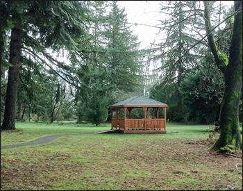 12 x 16 Cedar Rectangular Gazebo shown with Gray Composite Deck. 1x3 Railings, 36" High Railings, Standard Posts, Standard Braces, No Top Railing Section, Straight fascia, No Cupola, Cedar Tongue and Groove Ceiling, Rustic Evergreen Asphalt Shingles, Cedar Stain/Sealer, Stainless Steel Hardware, 4x4 Runners, and Hidden Wiring w/ 1 Receptacle and Switch.