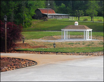 12 x 24 Vinyl Elongated Hexagon Belle Gazebo shown with Rustic Cedar Asphalt Shingles, Cupola with Copper Top, and Electrical Package. 