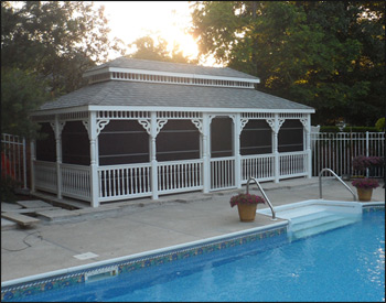 12 x 24 Vinyl Rectangular Double Roof Gazebo shown with no deck, 2x2 decorative spindle rails, decorative posts, decorative braces, straight fascia, no cupola, 4 track window system with screens, cedar tongue and groove ceiling, Old English Pewter asphalt shingles, Oil Rubbed Bronze Nedmac Outdoor Ceiling Fan w/ Pecan Palm Leaf Blades, stainless steel hardware, Hidden Wiring w/ 1 Receptacle & Switch, and extra receptacle. 