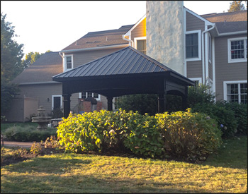 14 x 14 Vinyl Ramada shown with Black Vinyl, Deluxe Package with Square Vinyl Columns, Taller Posts, Black Metal Roof, and Clear Ceiling Stain.