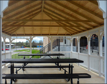 16 x 24 Vinyl Rectangular Gazebo shown with Standard White Vinyl, Treated Pine deck, 1x1 Standard Railings, Standard Braces, Straight Fascia, 4x4 Runners, Additional Entrance,and Old English Pewter Asphalt Shingles. 