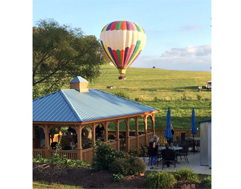   18 x 30 Treated Pine Rectangular Gazebo shown with Cupola, Blue Metal Roof, and Clear Stain/Sealer. Hot Air Balloon by others!